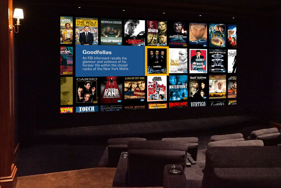 Private home theater with large screen displaying Kaleidescape and plush seating for an immersive viewing experience.