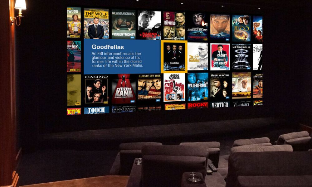 Private home theater with large screen displaying Kaleidescape and plush seating for an immersive viewing experience.